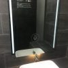 Touchscreen virtual bathroom mirror with TrueLight LED light.
